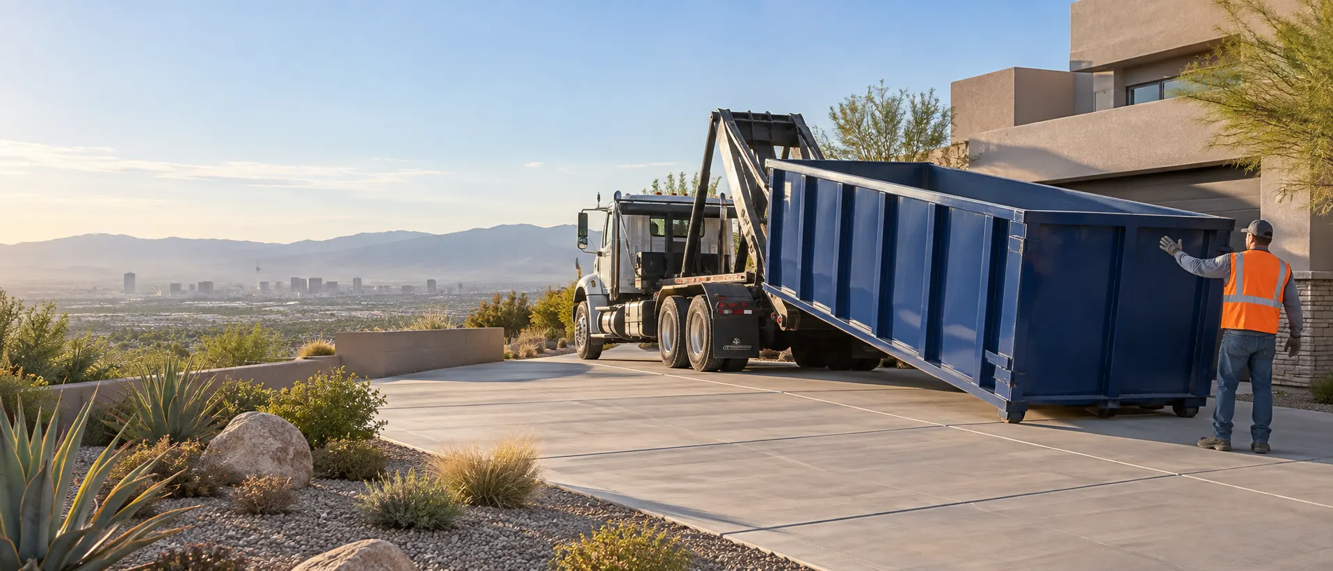 Roll-off dumpster being positioned on a desert residential driveway